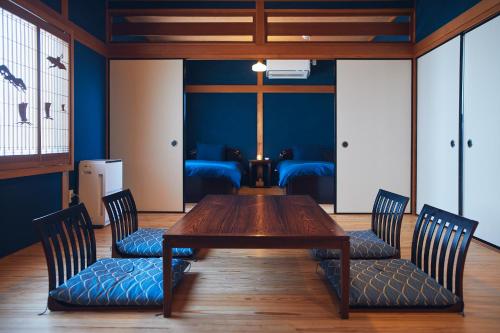 a dining room with a wooden table and chairs at Suikomareso in Hita
