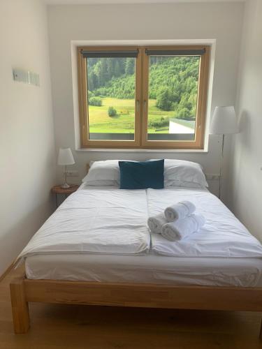 a bedroom with a large bed with towels on it at Sprungschanze Haus in Murau