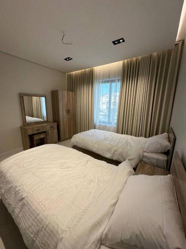 Postel nebo postele na pokoji v ubytování دانة هوم