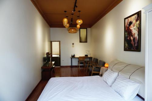 a bedroom with a bed and a living room at Lotus en Laine Maison de Hanoi - Stunning Full Three Story House with Balcony in Hanoi