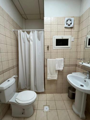 a bathroom with a toilet and a sink at فندق قوافل الشام in Tabuk