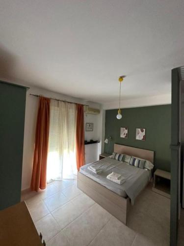 a bedroom with a bed and a large window at Central Apart. 4U in Ierapetra