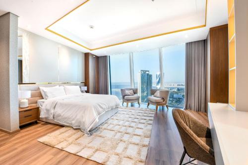 a bedroom with a bed and a large window at Luxury Seaview Penthouse Harbour Heights in Manama