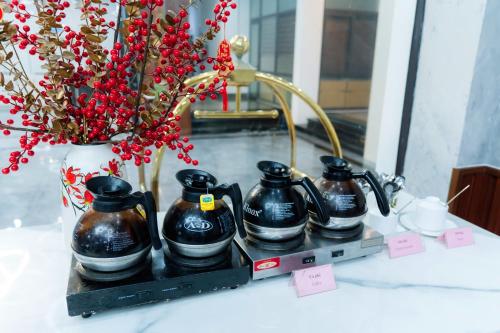 a table with a vase with a bunch of flowers at Bạch Đằng Hạ Long Hotel in Ha Long