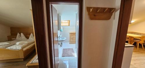 a bathroom with a shower and a bedroom with a bed at Residence Blumenthalerhof in Lagundo