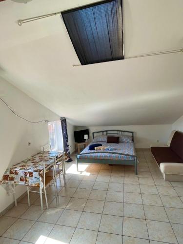 a bedroom with a bed and a couch and a table at Dejan apartment4-Top centar in Pula