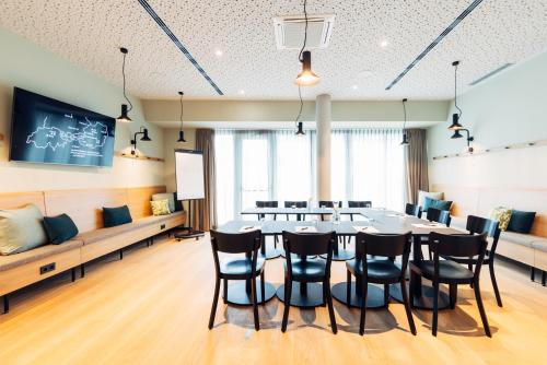 a conference room with a table and chairs at harry's home Lienz hotel & apartments in Lienz