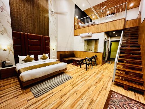 a hotel room with a bed and a staircase at Hotel The Onix in Dehradun