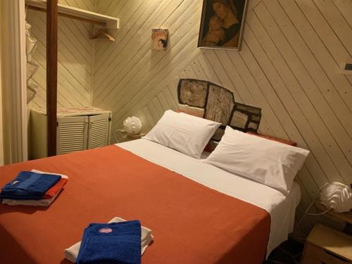a bedroom with a large bed in a room at Cottage Milvia piscina privata rifugio romantico vicino al mare in Tortoreto Lido