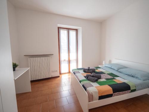 a bedroom with a bed with a quilt on it at Magnolia House in Bellano