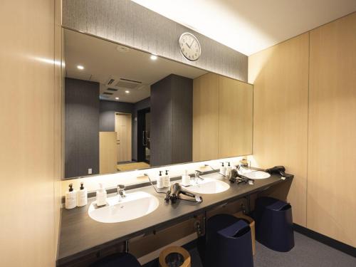 a bathroom with two sinks and a large mirror at La'gent Hotel Kyoto Nijo in Kyoto
