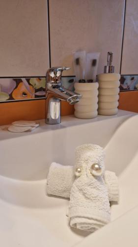 a towel sitting on a sink next to a faucet at Apartments Manuel in Rab