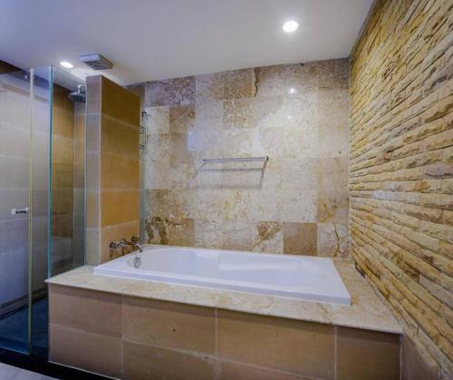 a bathroom with a tub and a glass shower at Seaview Condo with Large Pool - BAP1 in Phuket Town