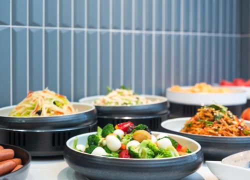 a bunch of plates of food on a table at Holiday Inn Express Zhengzhou Garden Road in Zhengzhou