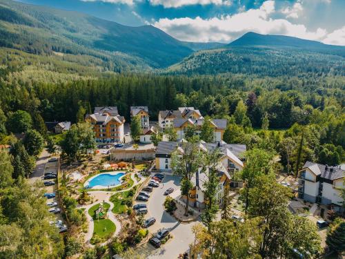 an aerial view of a resort with a pool and mountains at Green Apartments in Karpacz