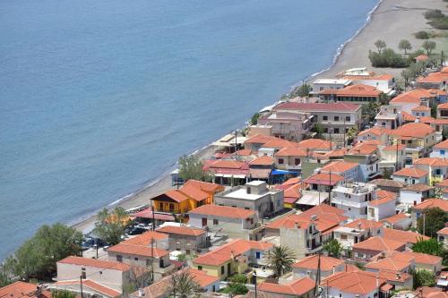 a group of houses on a hill next to the beach at Chliara apartments by Tzalas in Skala Eresou