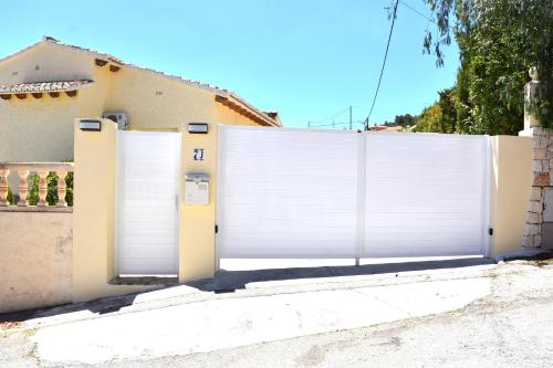 a white garage door in front of a house at Villa Cucarres in Calpe