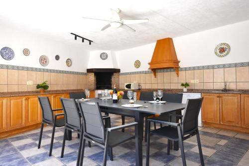 a dining room with a table and chairs in a kitchen at Villa Cucarres in Calpe