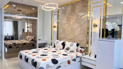a bedroom with a large bed and a mirror at Apartment Medan Podomoro City Deli by OLS Studio in Medan