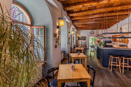 a restaurant with wooden tables and a bar at Le Rive Sud in Estavayer-le-Lac