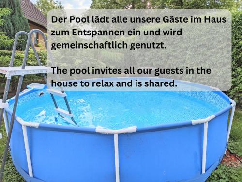 a blue bath tub with a slide in a yard at W3 - Urlaubsmagie - Maisonette-Wohnung mit Pool in Lichtenhain