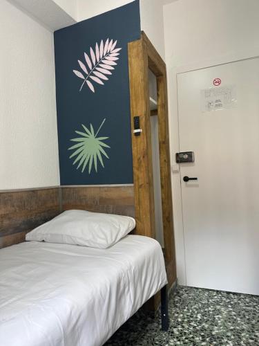 a bedroom with a bed and a wall with a flower mural at Pension RIOKA CALPE in Calpe