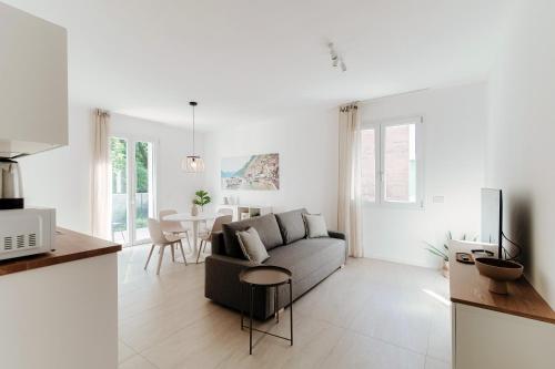 a living room with a couch and a table at Lario Suite Apartments by Quokka 360 - With parking Next to Como City in Como