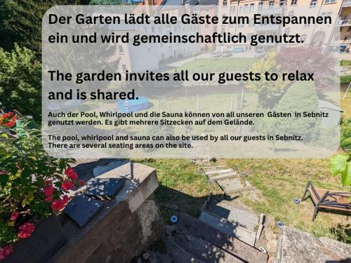 a sign for a garden with a bench and flowers at HW4B - Urlaubsmagie - Zentral mit Gemeinschaftsgarten, -Pool, -Sauna & Whirlpool in Sebnitz