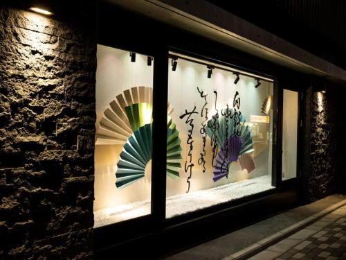 a window of a store with displays of plants at La'gent Hotel Kyoto Nijo in Kyoto