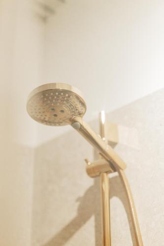 a shower with a shower head in a bathroom at GREEN Apartments in Vienna