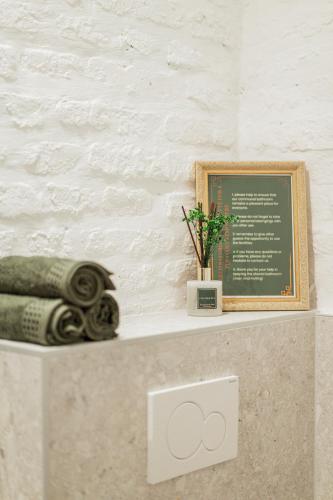 a counter with a sign and a plant on it at GREEN Apartments in Vienna