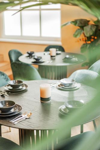 a table with plates and cups on top at GREEN Apartments in Vienna