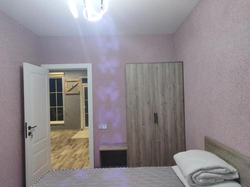 a bedroom with a bed and a door to a hallway at Events Park Qebele in Gabala