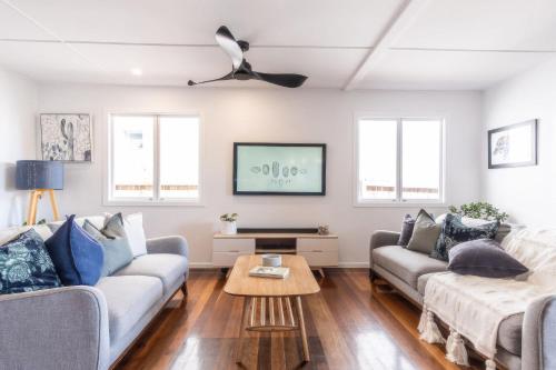 a living room with two couches and a coffee table at 'The Otto' At Moffat Beach in Caloundra