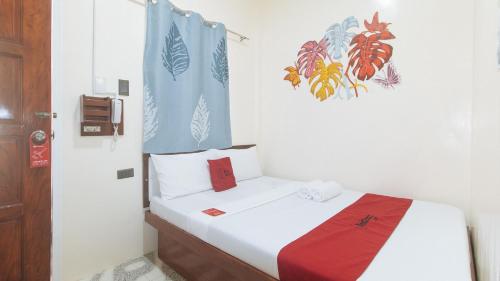 Postel nebo postele na pokoji v ubytování RedDoorz at Queens Hometel