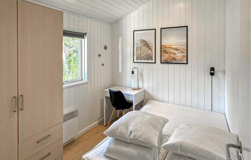 a white bedroom with a bed and a desk at Holiday Home Nørtvedvej Strandby Denm in Strandby