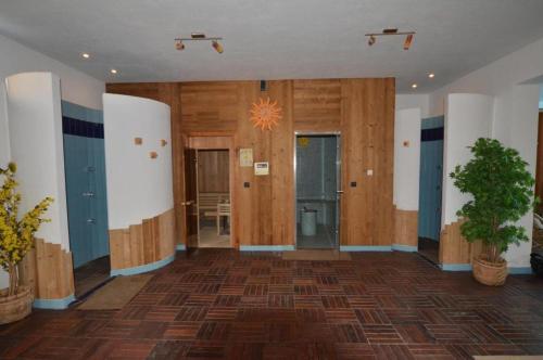 a large room with wooden floors and a plant at Apartments Ana Wellness L in Rovinj