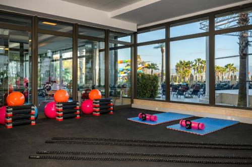 a gym with yoga mats in front of a building at Liberty Kuşadası in Kusadası