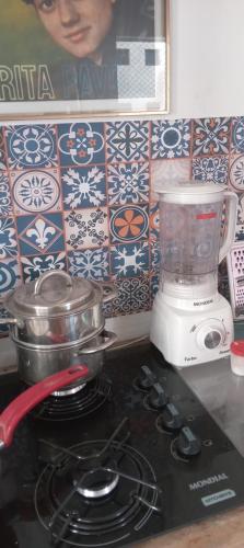 a kitchen stove with a blender on top of it at Luz de Regina Hospedagem in Salvador