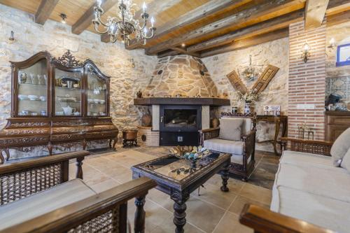 a living room with a couch and a fireplace at El Rincón de Hornuez in Moral