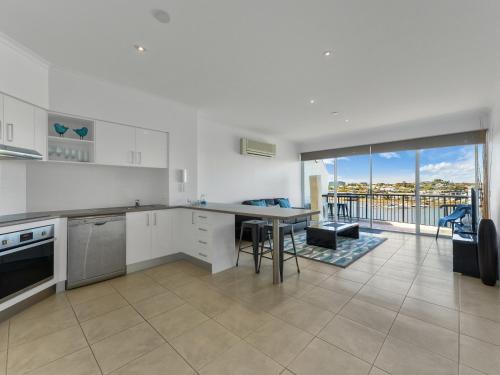 a kitchen with a stove, sink, and refrigerator at Goldsborough Place Apartments in Brisbane