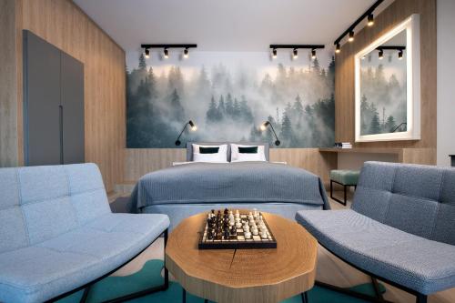 a bedroom with a bed with a chess board on a table at VISLOW Resort in Wisła