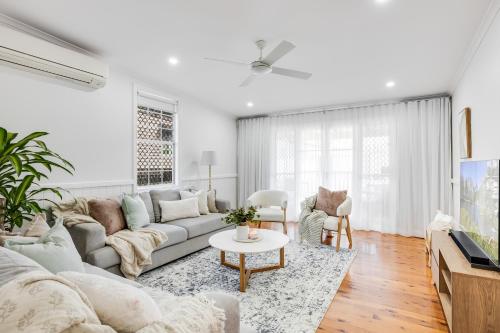 a living room with a couch and a table at A Charming, Central & Family Friendly Cottage in Toowoomba