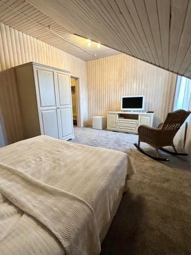 a bedroom with a bed and a tv and a chair at LAVANDA country club in Tatariv