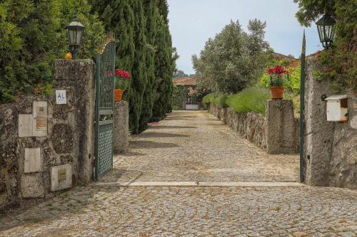 an empty street with a gate and trees at Cosy apartment at Portuguese Quinta in Casal Diz