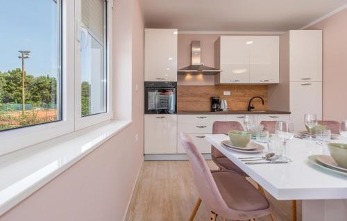 a kitchen and dining room with a table and chairs at Amazing Home In Zadar With Wifi in Zadar