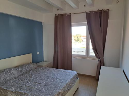 a bedroom with a bed and a window at La nuvola in Fiumicino