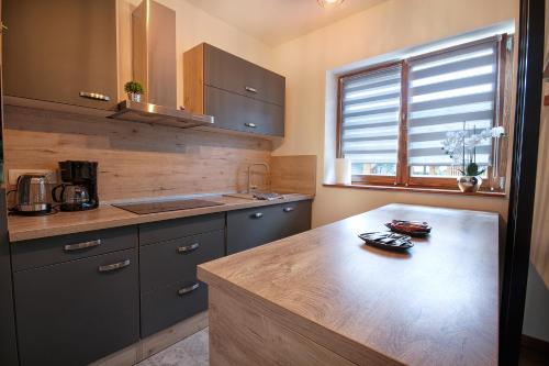 a kitchen with a wooden counter top and a sink at Charming house Maša in Rakovica