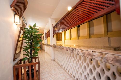 a restaurant with a counter with a potted plant at Cara Galle Fort in Galle