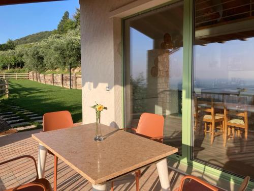 a table and chairs on a patio with a view of the ocean at La Terrazza in Collina in Cavalo